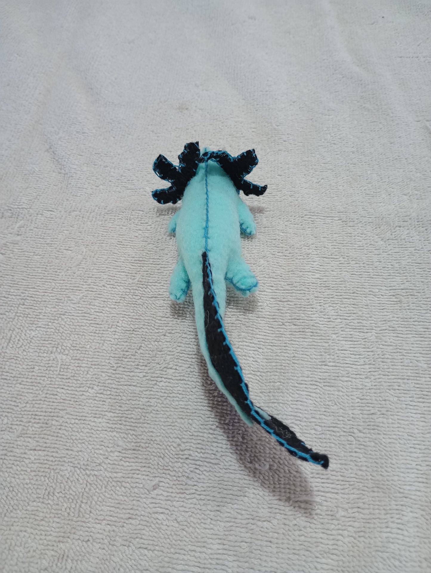 Blue and black axolotl guy crystal: random